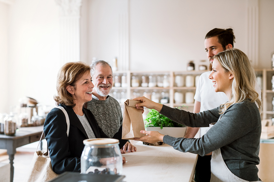 Senior Couple Buying Groceries In Zero Waste Shop, Sales Assista