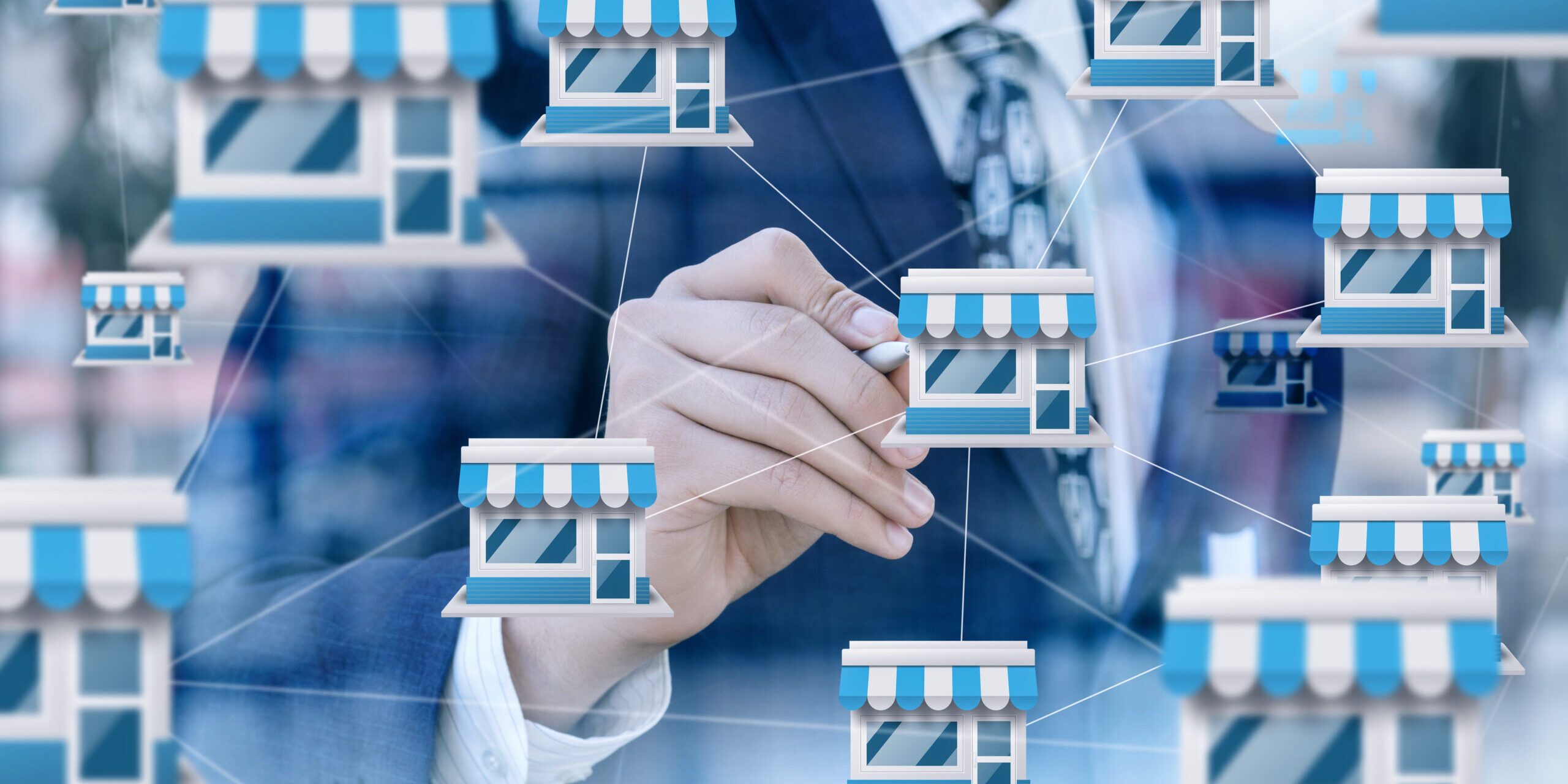 Businessman demonstrates linking retail chain locations.