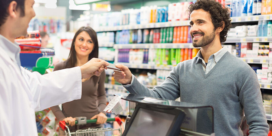 Customer using a credit card to pay in a supermarket